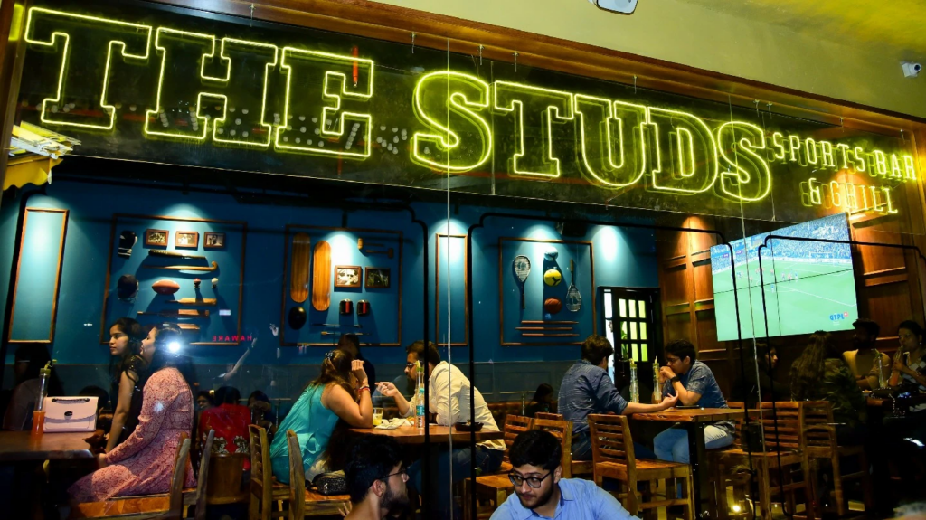 Modern sports bar design with large screens, premium seating, and immersive fan experience at The Studs | The Studs
