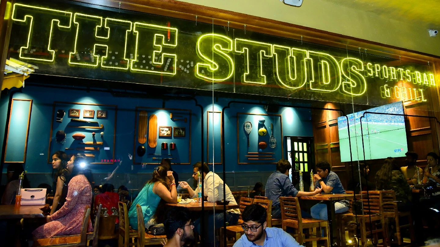 Modern sports bar design with large screens, premium seating, and immersive fan experience at The Studs | The Studs